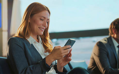 A woman on her mobile phone at the airport.