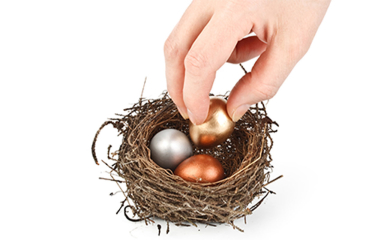 A hand putting eggs in a nest.