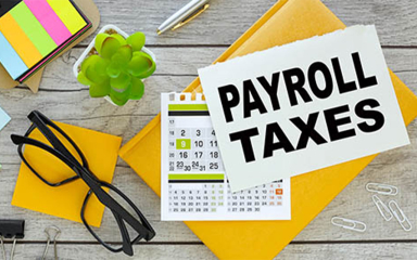 Book, post-its, paper clips, glasses, a plant, calculator, and pen on a table.