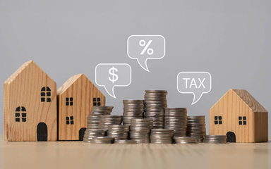 Wooden houses and stacks of coins.