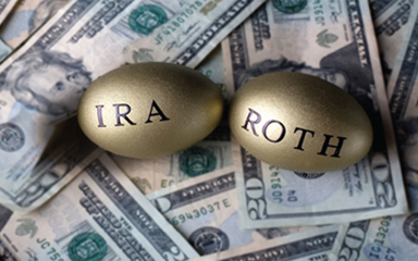 Two golden eggs sitting on $20 bills.