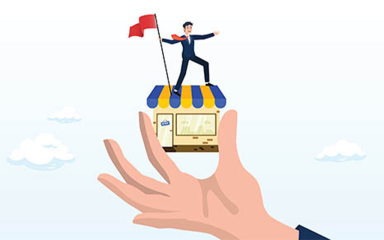 A hand holding a shop with a person in a suit standing on top, holding a flag.