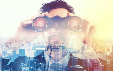 A man looking over a city skyline with binoculars.