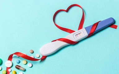 A ribbon wrapped around a positive pregnancy test.