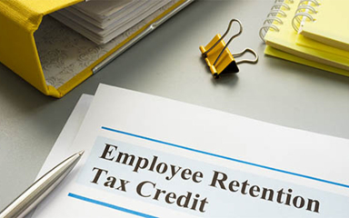 Paper, notebooks, binder and pen on a desk.
