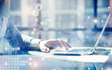 A mans hand on a laptop mouse pad sitting on a desk.