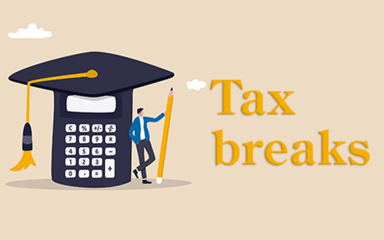 A person holding a pencil, leaning against a large calculator with a graduation cap on top.