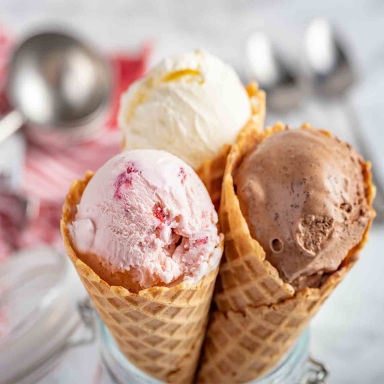 strawberry, vanilla, chocolate ice cream woth waffle cone on marble stone backgrounds