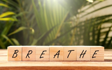 Wooden blocks on a table linked up to spell breathe