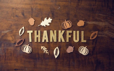 fall themed cutouts on a table with the word thankful