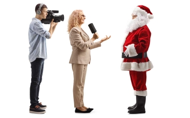 Santa talking to a reporter and cameraman.