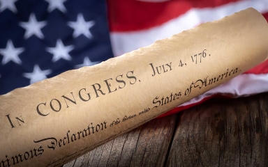 The US Constitution and an American flag.