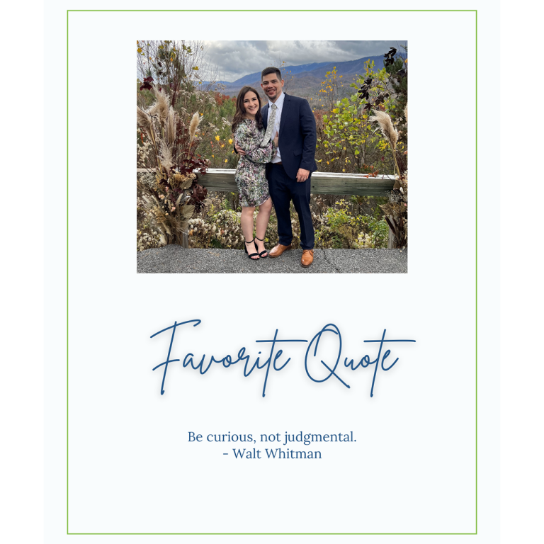 A man and woman posing for a photo in front of a mountain landscape.