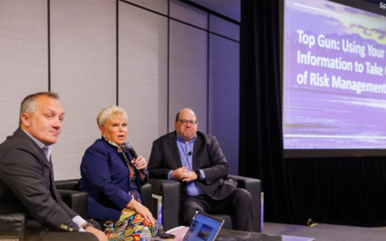 Business professionals on a stage at a conference.