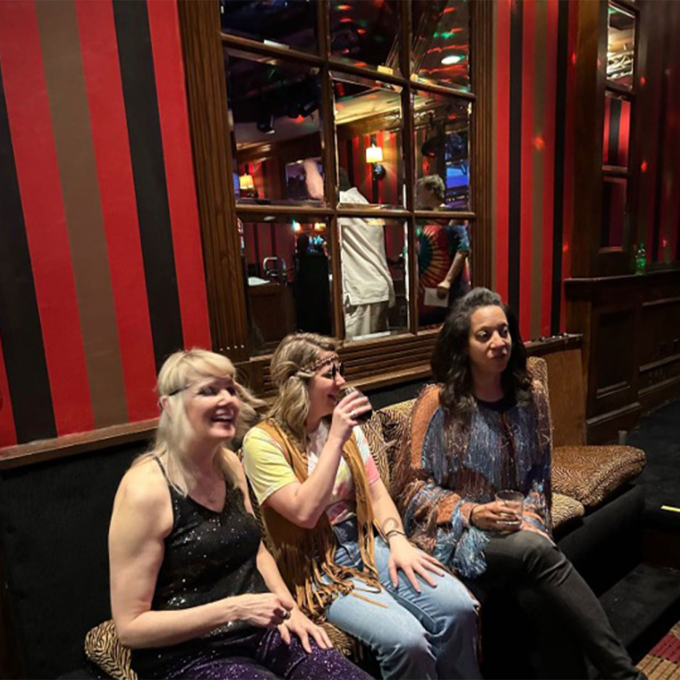 Three women sitting on a couch.