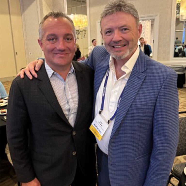 Two business professionals embracing.