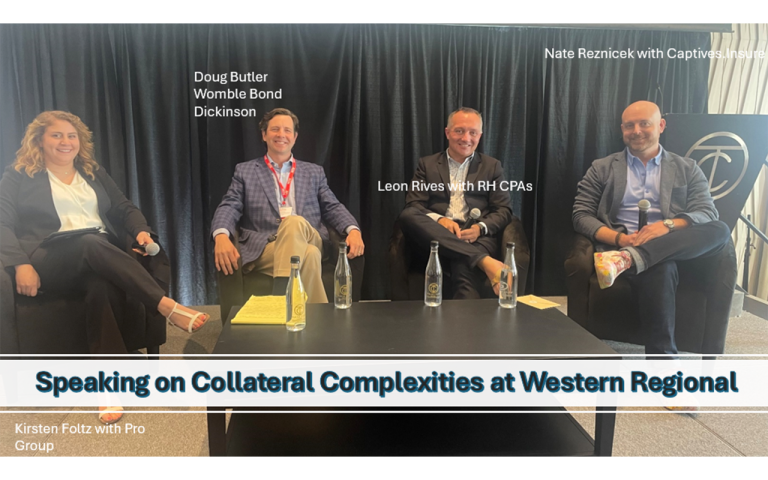 Four professionals, in chairs, with microphones, on a stage.