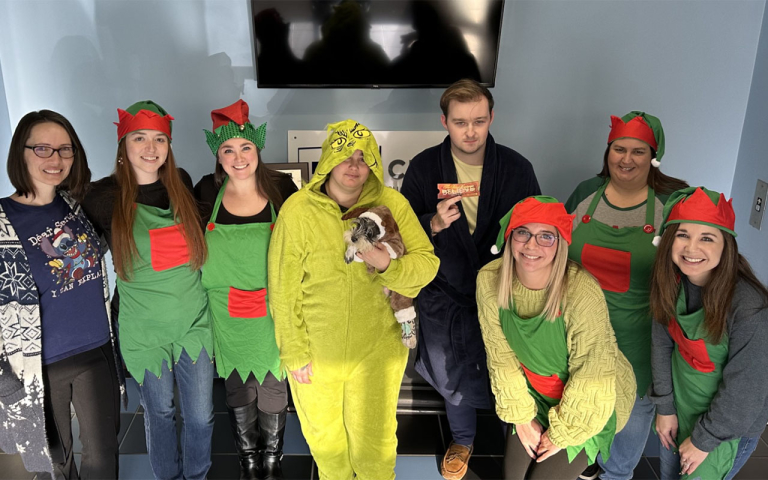 Business professionals wearing Christmas items.