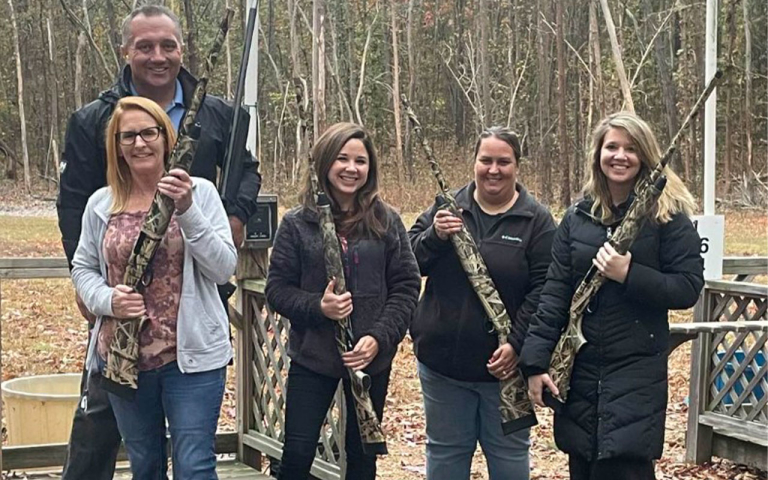 Four women holding shotguns.