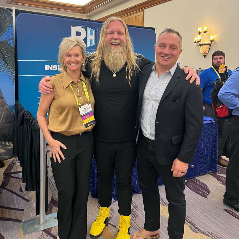 Three people smiling for a photo.