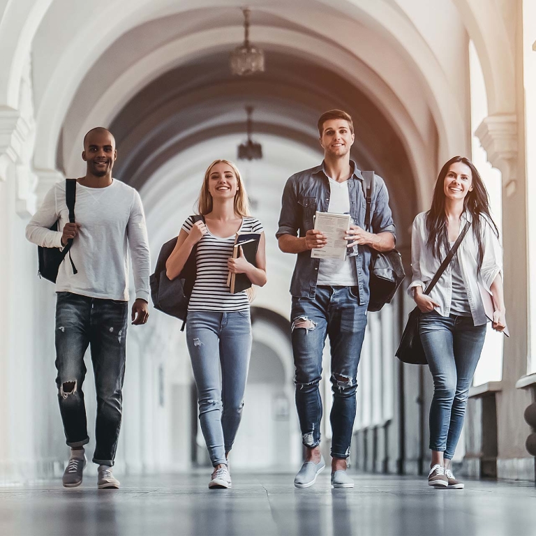 Four students walking side by side.