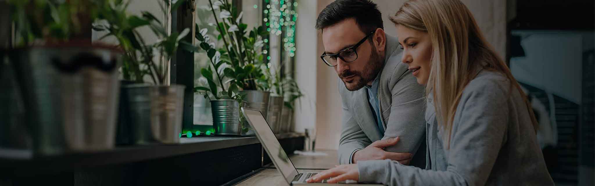 two coworkers viewing a laptop screen