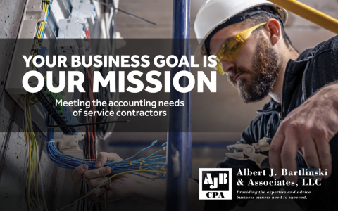 Electrician holding a handful of wires and pliers.