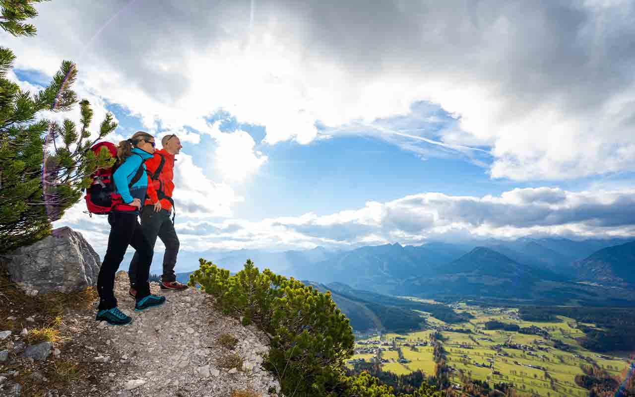 man and woman on a cliff