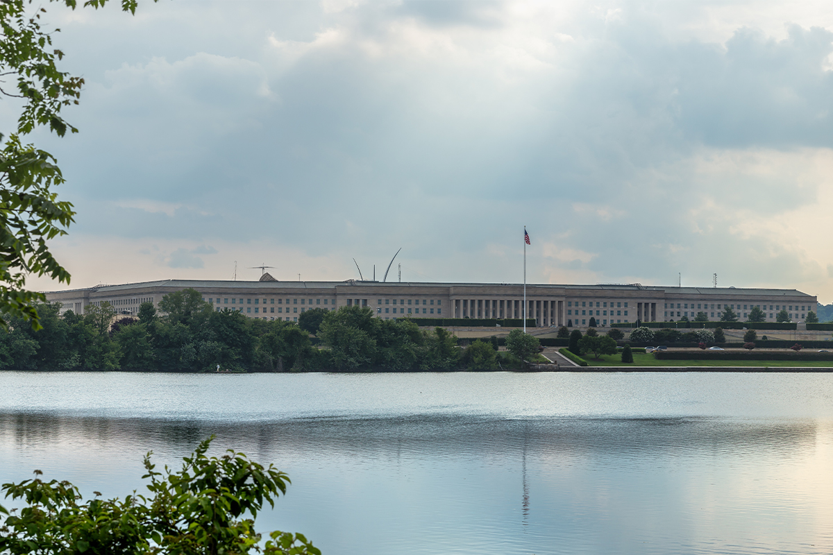 A lake with a government building near the banks.