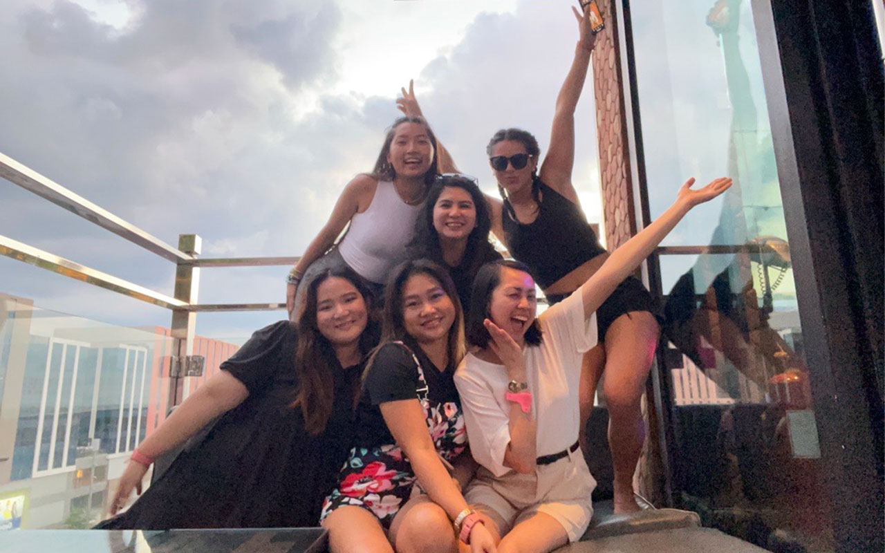 Young women posing for a group photo.