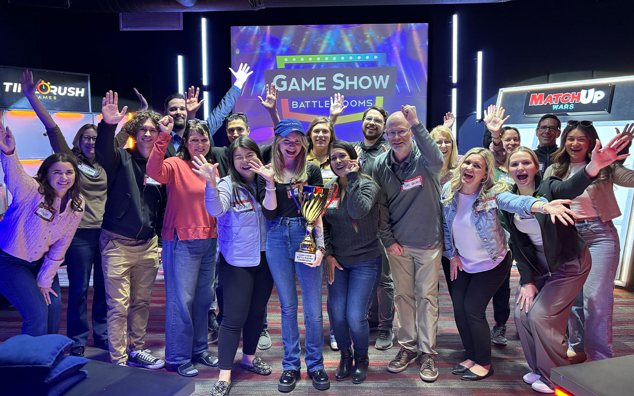 A group of people posing for a photo, holding a trophy.