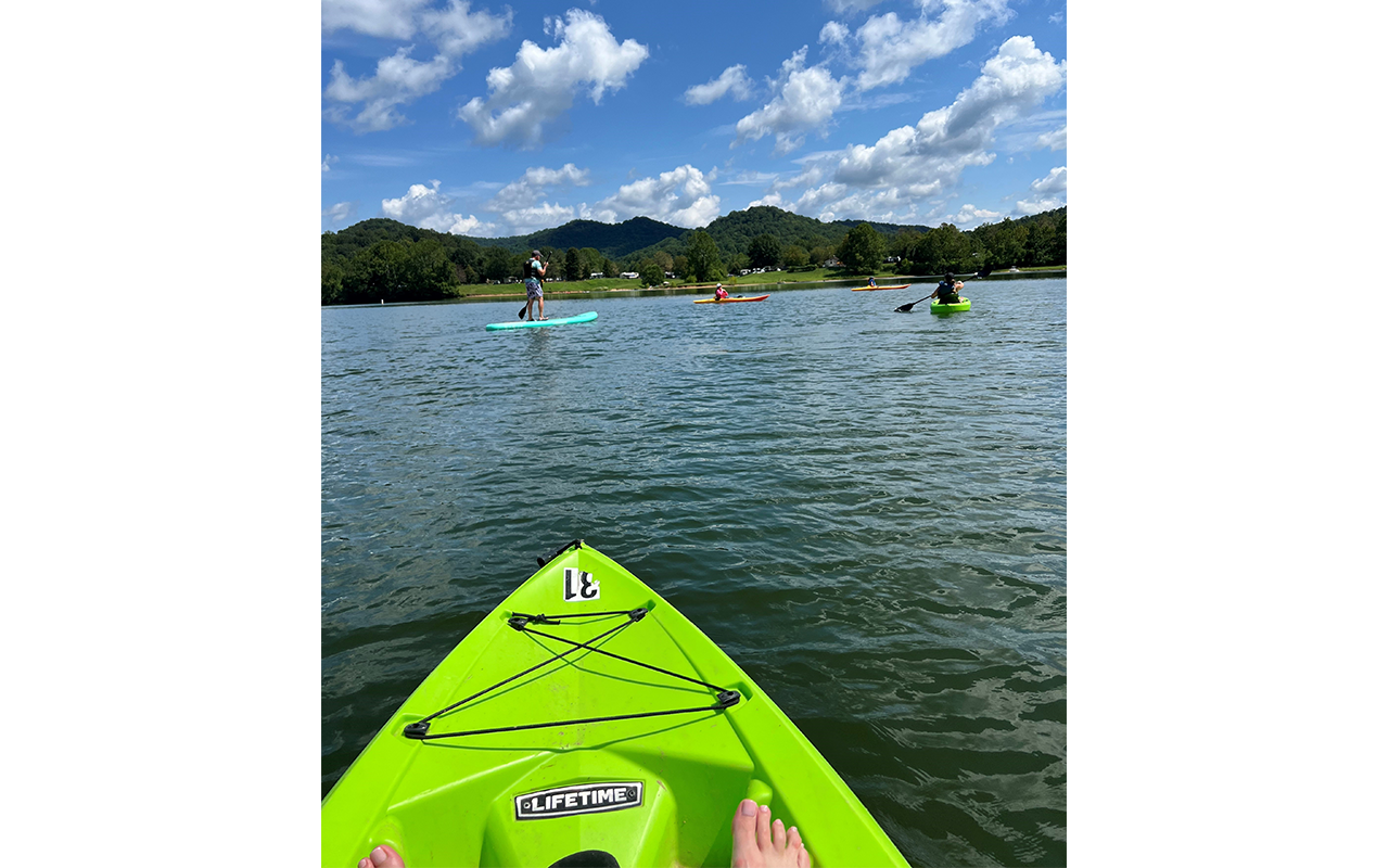 Kayaking and paddle boarding on a lake.