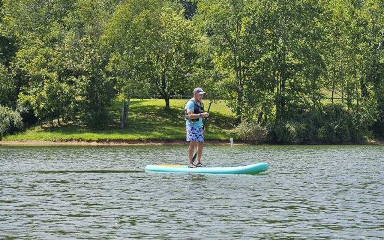 Man paddle boarding on a lake.