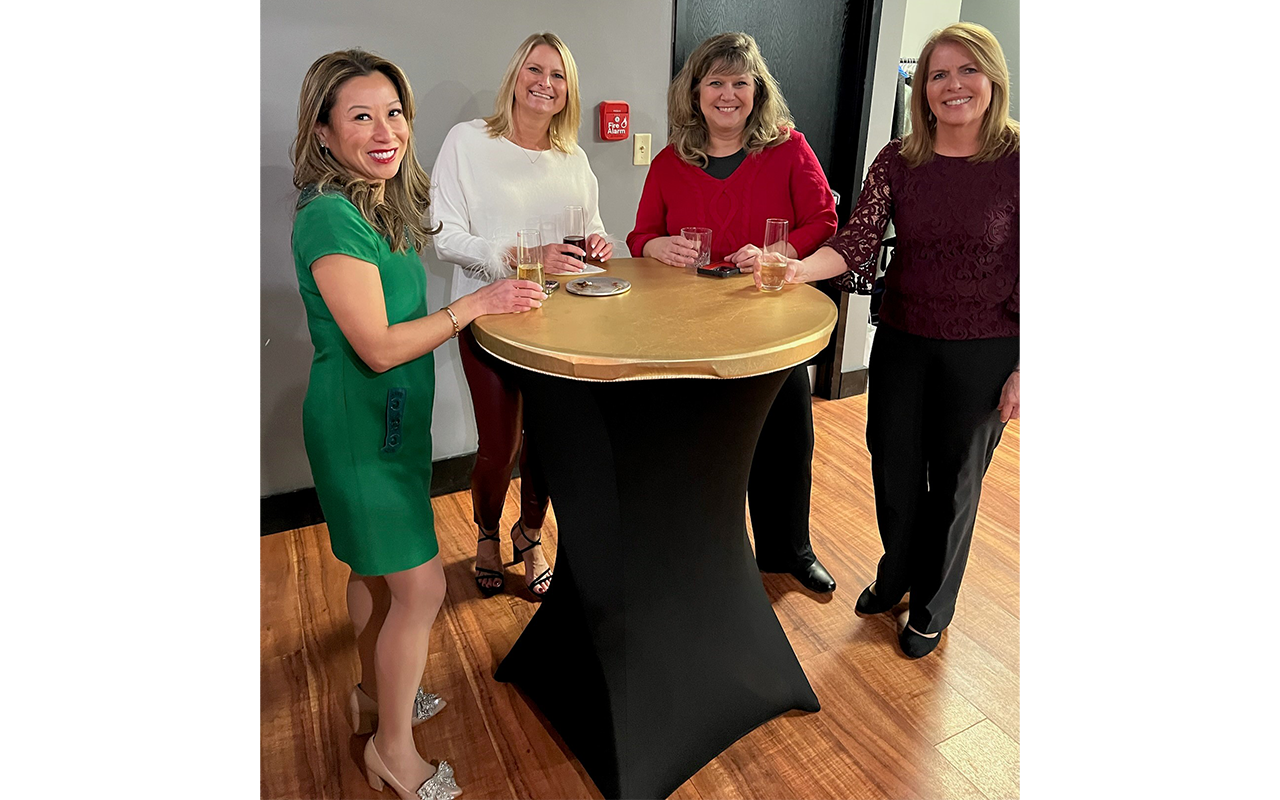 Four female business professionals at a Christmas party.