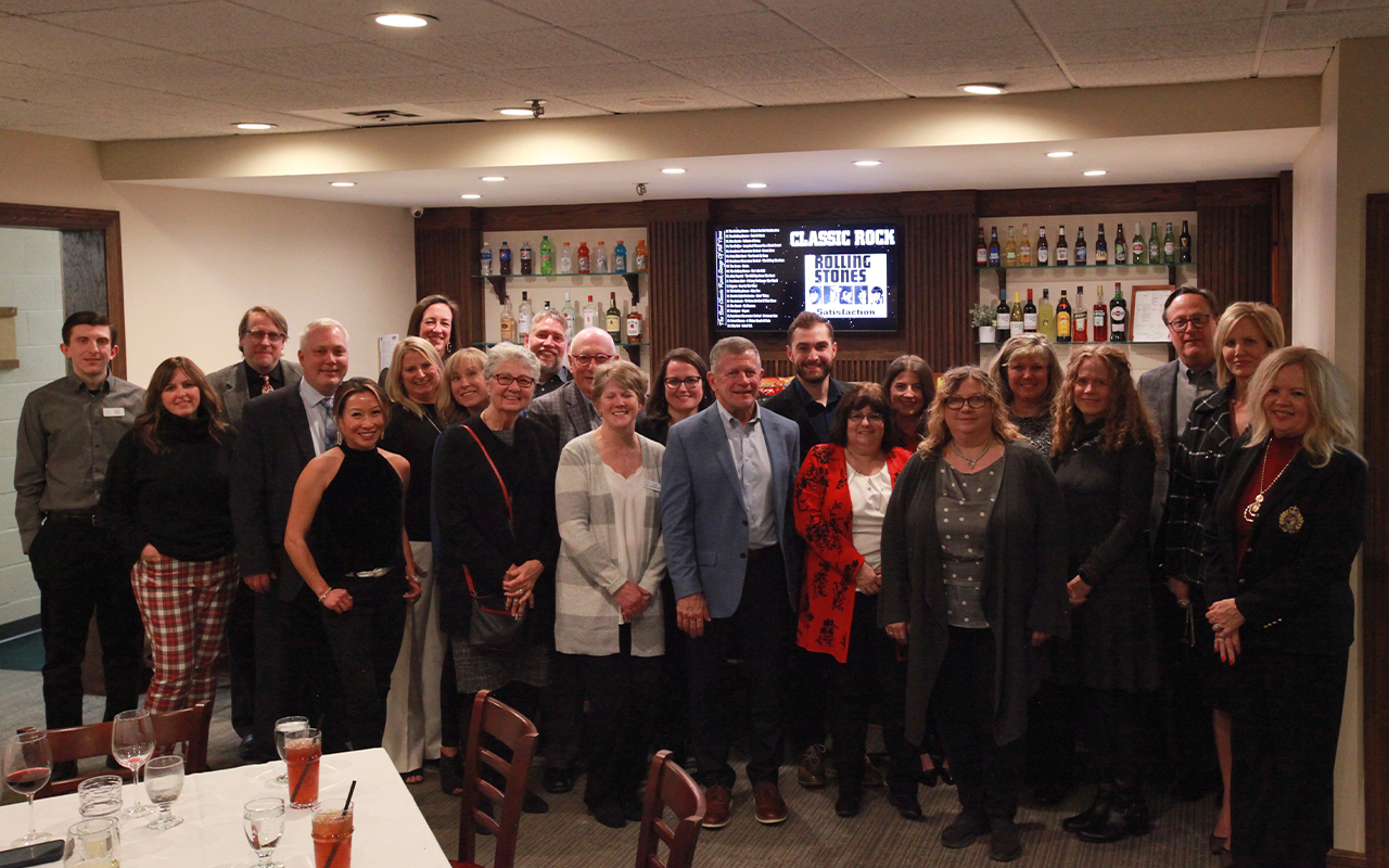 A group photo of business professionals at a Christmas party.