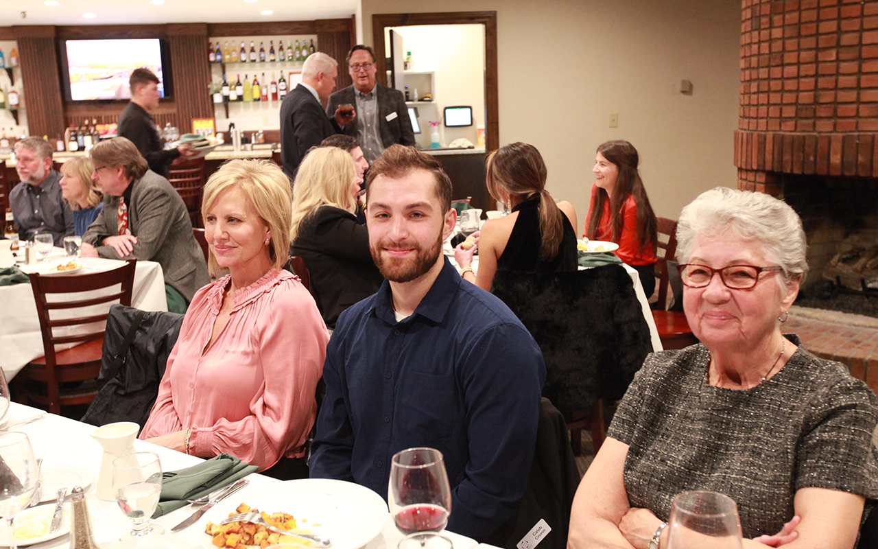 People eating a meal and talking at a Christmas Party.