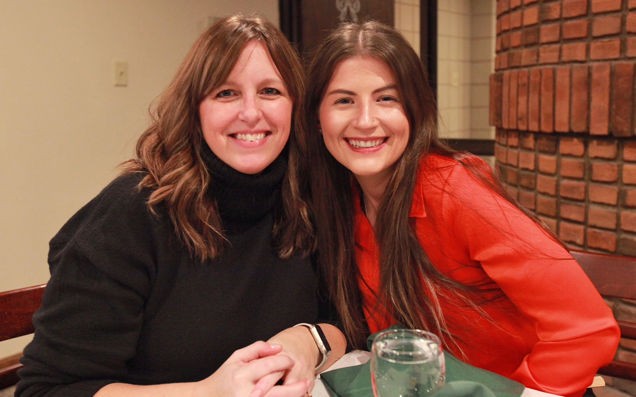 Two female coworkers enjoying a Christmas party.