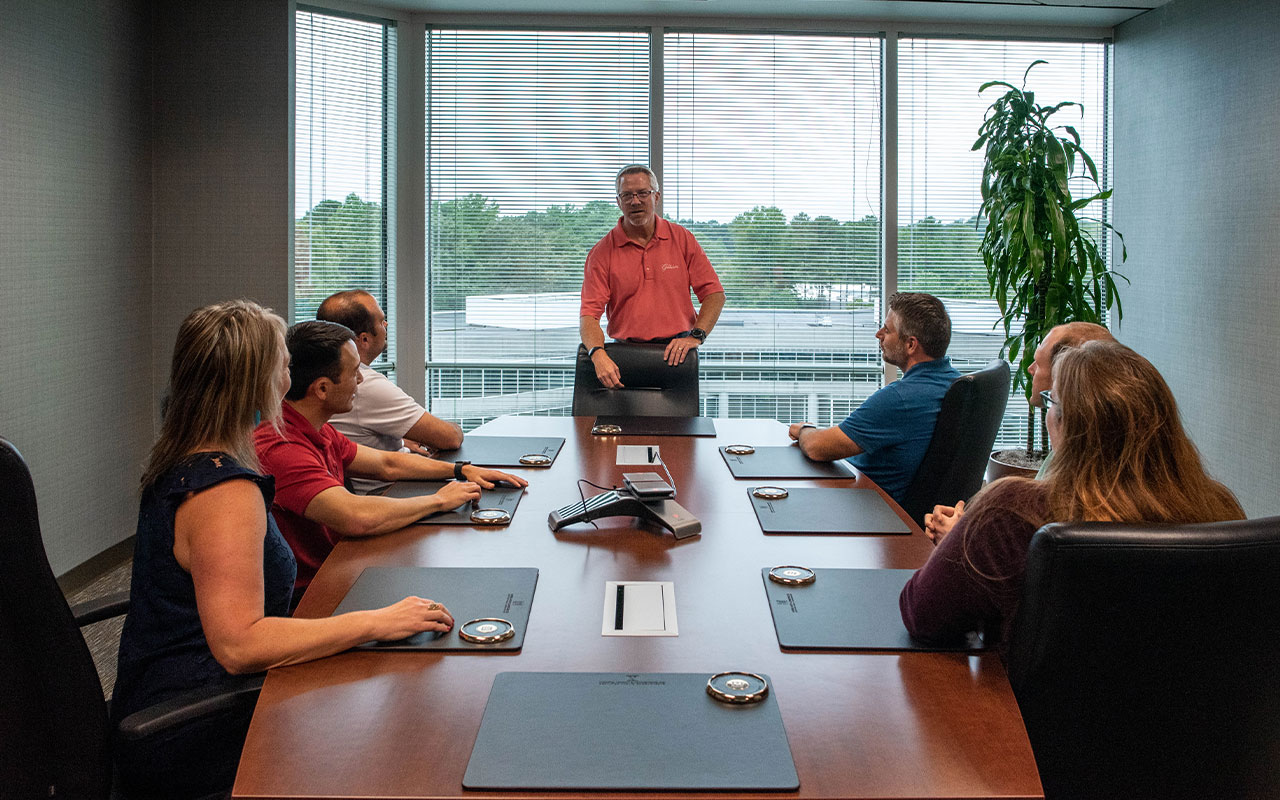 Business professionals meeting around a conference table.