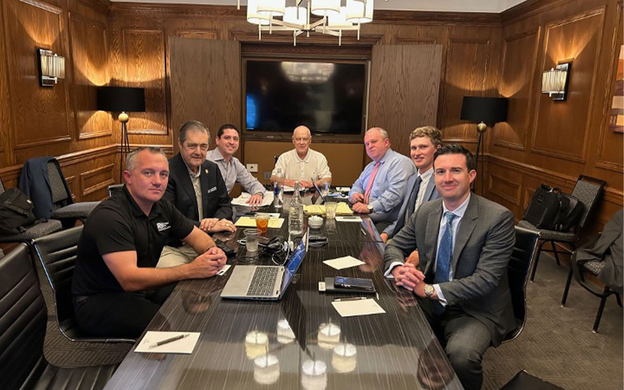 Group of business professionals in a board room setting.