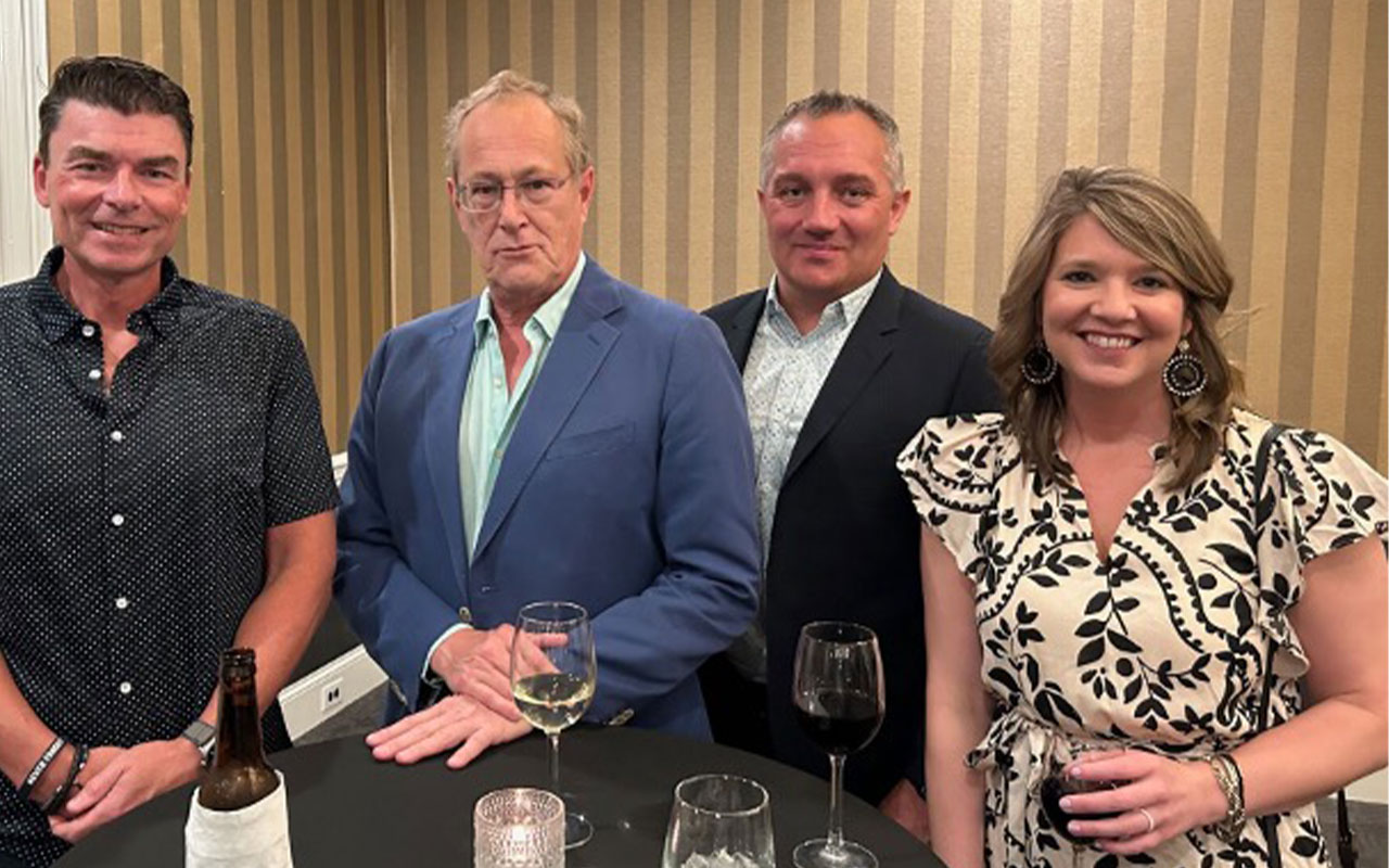 Accounting professionals posing with drinks.