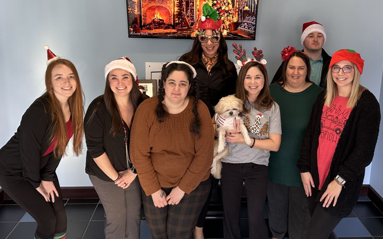 Business professionals wearing Christmas items.