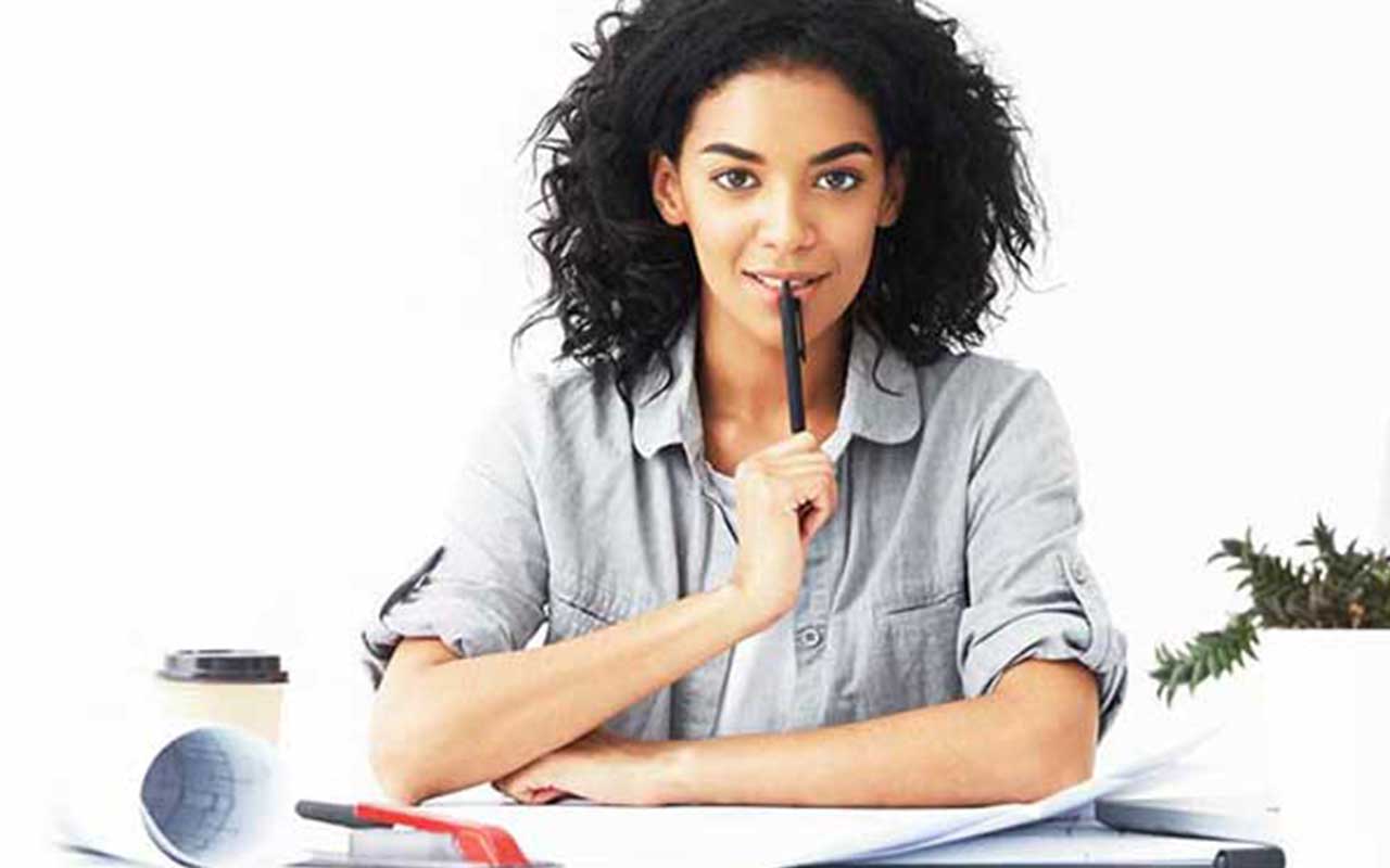 An architectural designer sitting at a table working