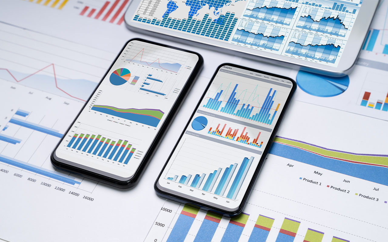 Cell phones and a tablet with graphs on them.