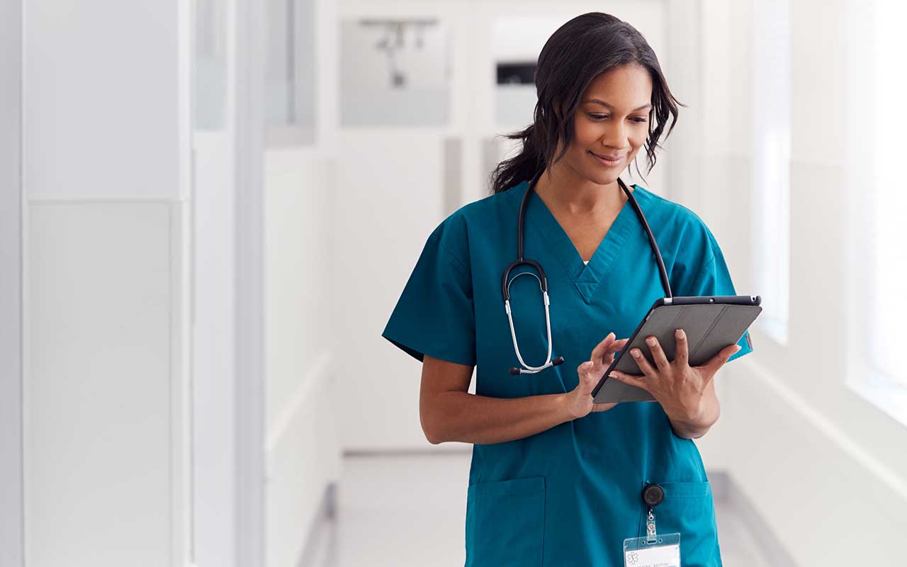 A healthcare worker looking at a tablet