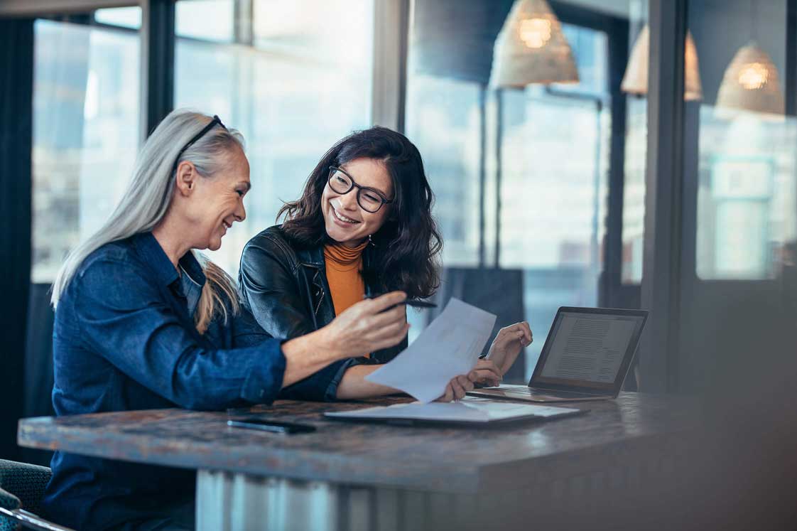 Two Women At A Table Working