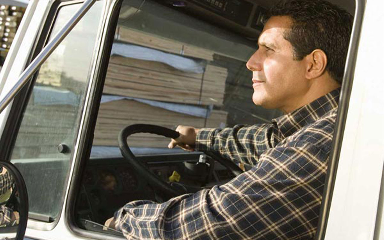 Man driving a semi truck.