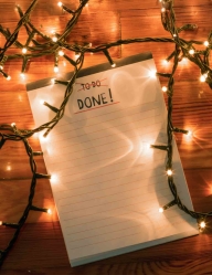 To do list notepad with tangled Christmas lights, top view.