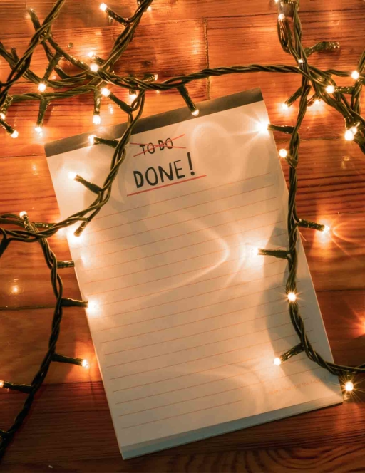 To do list notepad with tangled Christmas lights, top view.