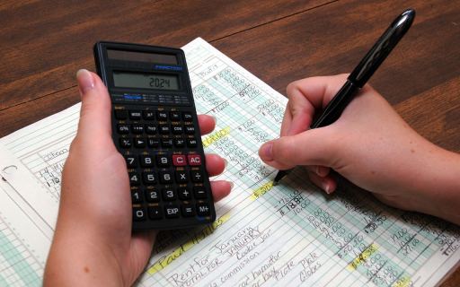 Calculator, pen and ledger.