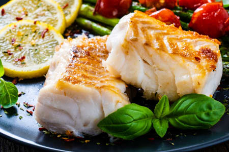 Gebratenes Kabeljaufilet mit frischem Gemüse.